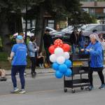 Sara Reinert, right, pushes a book cart with the Friends of the Homer Public Library group during the Homer Fourth of July parade on Monday, July 4, 2022, on Pioneer Avenue in Homer, Alaska. (Photo by Michael Armstrong/Homer News)