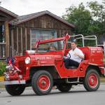 A man drives the Homer Volunteer Fire Departments Engine No. 1 Willys Jeep during the Homer Fourth of July parade on Monday, July 4, 2022, on Pioneer Avenue in Homer, Alaska. (Photo by Michael Armstrong/Homer News)