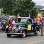 Homer High School graduates from the 1970s ride in an antique Chevrolet pickup truck as Homer Mayor Ken Castner follows during the Homer Fourth of July parade on Monday, July 4, 2022, on Pioneer Avenue in Homer, Alaska. The theme of the parade was The First 50 Years: Celebrating Homer High School Graduates from 1940-1990. The 1970s group won Best Use of Theme for the parade. (Photo by Michael Armstrong/Homer News)
