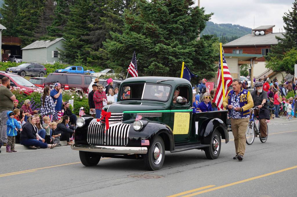 Homer High School graduates from the 1970s ride in an antique Chevrolet pickup truck as Homer Mayor Ken Castner follows during the Homer Fourth of July parade on Monday, July 4, 2022, on Pioneer Avenue in Homer, Alaska. The theme of the parade was The First 50 Years: Celebrating Homer High School Graduates from 1940-1990. The 1970s group won Best Use of Theme for the parade. (Photo by Michael Armstrong/Homer News)