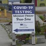 A new sign on July 2, 2022, on Pioneer Avenue and Bartlett Street indicates the new times and days for the South Peninsula Hospital COVID-19 testing and vaccine clinic on Bartlett Street. (Photo by Michael Armstrong/Homer News)