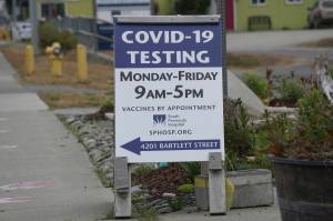 A new sign on July 2, 2022, on Pioneer Avenue and Bartlett Street indicates the new times and days for the South Peninsula Hospital COVID-19 testing and vaccine clinic on Bartlett Street. (Photo by Michael Armstrong/Homer News)