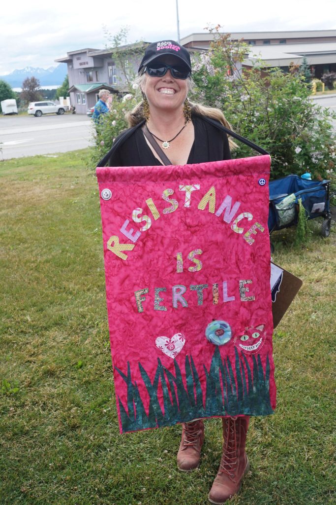 Carly Wier holds a sign that reads Resistance is Fertile at the Womens March: Bans Off Our Bodies protest on Saturday, July 9, 2022, at WKFL Park in Homer, Alaska. (Photo by Michael Armstrong/Homer News)