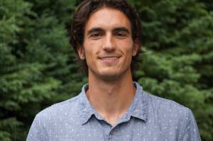 New Homer News reporter Charlie Menke poses for a photo on Friday, July 8, 2022, at the Homer News in Homer, Alaska. (Photo by Michael Armstrong/Homer News)