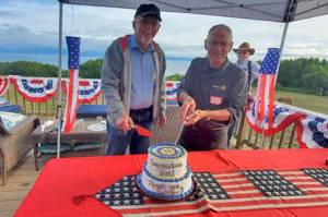 The Rotary Club of Homer-Kachemak Bay celebrated the accomplishments of one Rotary year and looked ahead to a new year at a social gathering July 1. Honored were Kim Zook, left, newly installed president of the club, and Bernie Griffard, immediate past president. At back is Marv Peters, a charter member of the club and one of the club’s directors.