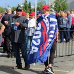 A person wearing a Trump flag stands outside of the Alaska Airlines Center, where a Save America rally was being held, on Saturday, July 9, 2022 in Anchorage, Alaska. Former President Donald Trump, U.S. Senate candidate Kelly Tshibaka and U.S. House candidate Sarah Palin were among the events speakers. (Ashlyn OHara/Peninsula Clarion)