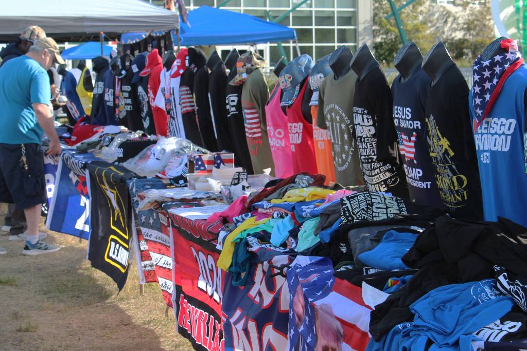 Save America rally attendees shop for merchandise outside of the Alaska Airlines Center on Saturday, July 9, 2022 in Anchorage, Alaska. Former President Donald Trump, U.S. Senate candidate Kelly Tshibaka and U.S. House candidate Sarah Palin were among the events speakers. (Ashlyn OHara/Peninsula Clarion)