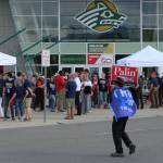 A man wearing a Trump flag crosses the street in front of the Alaska Airlines Center, where a Save America rally was being held, on Saturday, July 9, 2022 in Anchorage, Alaska. Former President Donald Trump, U.S. Senate candidate Kelly Tshibaka and U.S. House candidate Sarah Palin were among the events speakers. (Ashlyn OHara/Peninsula Clarion)