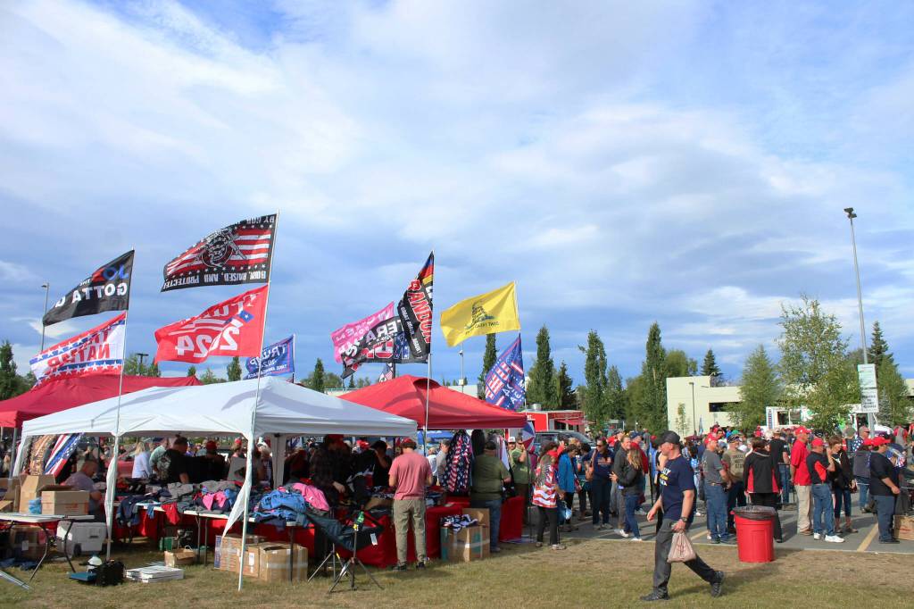 Vendors sell flags and other merchandise outside of the Alaska Airlines Center, where a Save America rally was being held, on Saturday, July 9, 2022 in Anchorage, Alaska. Former President Donald Trump, U.S. Senate candidate Kelly Tshibaka and U.S. House candidate Sarah Palin were among the events speakers. (Ashlyn OHara/Peninsula Clarion)