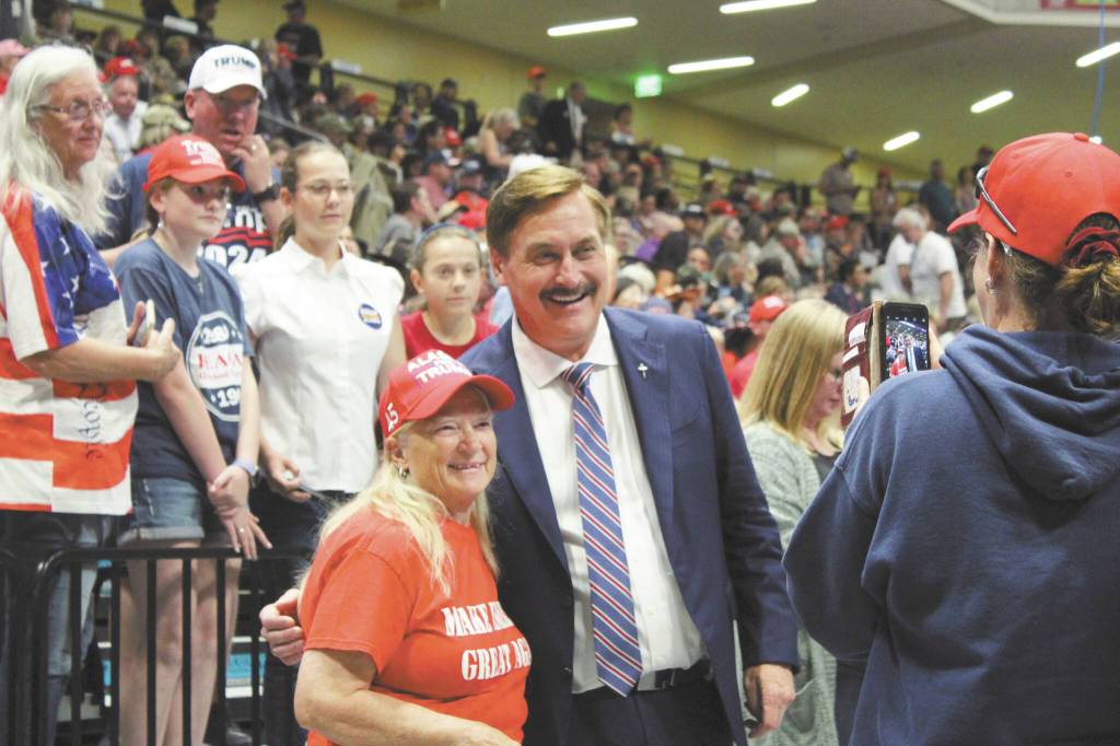 My Pillow CEO and political activist Mike Lindell poses with a Trump supporter Save America rally at the Alaska Airlines Center in Anchorage Alaska, on Saturday, July 9, 2022, in Anchorage, Alaska. (Photo by Ashlyn O'Hara/Peninsula Clarion)