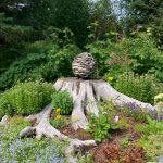 A garden at the home of Ralph Broshes and Deb Lowney features one of Lowneys sculptures. It was part of the walking tour portion of the Homer Garden Tour on Sunday, July 17, in Homer, Alaska. (Photo by Charlie Menke/Homer News)