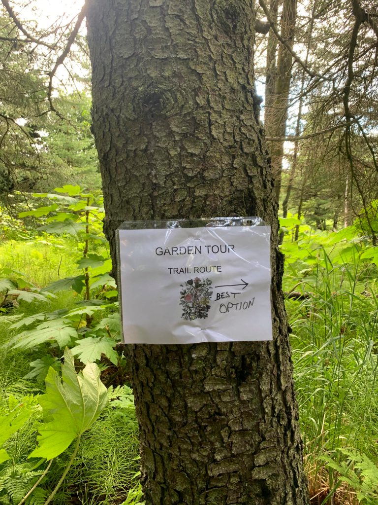 A sign marks the route on the walking portion of the Homer Garden Tour on Sunday, July 17, in Homer, Alaska. In downtown Homer, the tour allowed visitors to park their cars and walk from garden to garden, combining visits with a Sunday stroll. (Photo by Charlie Menke/Homer News)
