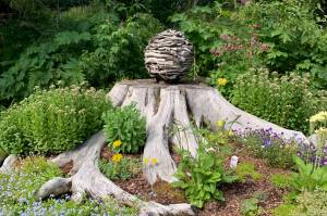 A garden at the home of Ralph Broshes and Deb Lowney features one of Lowney's sculptures. It was part of the walking tour portion of the Homer Garden Tour on Sunday, July 17, in Homer, Alaska.  (Photo by Charlie Menke/Homer News)