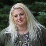 Callie Steinberg, the new multimedia sales consultant for the Homer News, poses for a photo on Tuesday, July 19, 2022, at the Homer News in Homer, Alaska. (Photo by Michael Armstrong/Homer News)