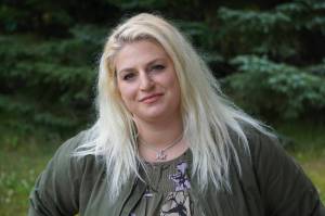 Callie Steinberg, the new multimedia sales consultant for the Homer News, poses for a photo on Tuesday, July 19, 2022, at the Homer News in Homer, Alaska. (Photo by Michael Armstrong/Homer News)