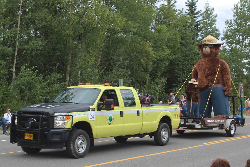An Alaska Division of Forestry vehicle pulls Smokey Bear during the 65th annual Soldotna Progress Days Parade on Saturday, July 23, 2022, in Soldotna, Alaska. (Ashlyn OHara/Peninsula Clarion)
