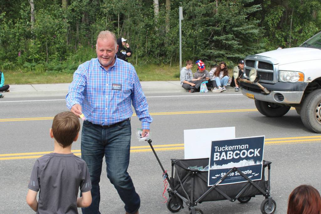 2022 Alaska State Senate candidate Tuckerman Babcock hands out candy during the 65th annual Soldotna Progress Days Parade on Saturday, July 23, 2022, in Soldotna, Alaska. (Ashlyn OHara/Peninsula Clarion)