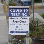 A new sign on July 2, 2022, on Pioneer Avenue and Bartlett Street indicates the new times and days for the South Peninsula Hospital COVID-19 testing and vaccine clinic on Bartlett Street. (Photo by Michael Armstrong/Homer News)