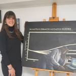 Kate Lochridge stands by one of her paintings for a pop-up show of her work on Friday, Aug. 5, 2022, at the Homer Council on the Arts in Homer, Alaska. (Photo by MIchael Armstrong/Homer News)