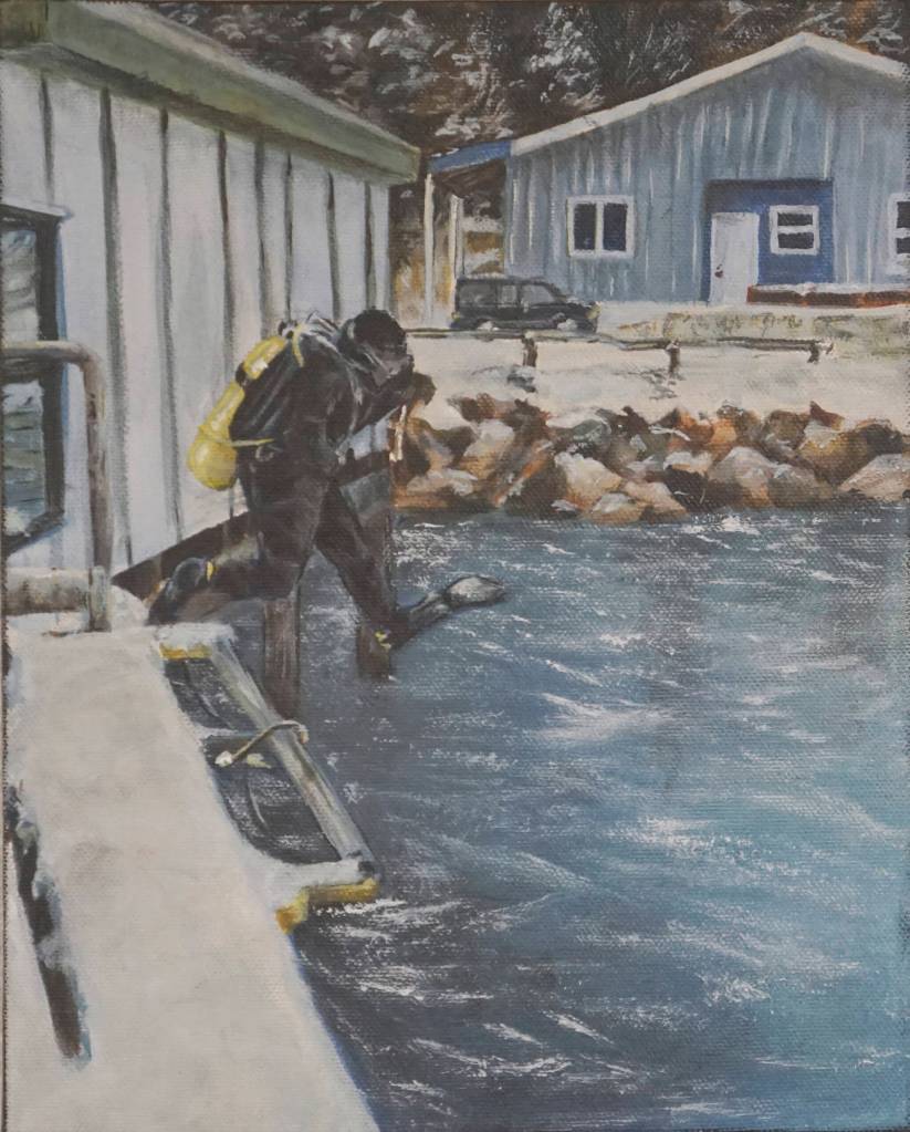 Kate Lochridges painting shows a scuba diver checking on a tidal gauge in Seldovia, Alaska. (Photo by MIchael Armstrong/Homer News)