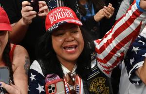 Mimi Israelah, center, cheers for Donald Trump inside the Alaska Airlines Center in Anchorage, Alaska, during a rally Saturday July 9, 2022. Two Anchorage police officers violated department policy during a traffic stop last month when Israelah, in town for a rally by former President Donald Trump showed a white privilege card instead of a drivers license and was not ticketed. (Bill Roth/Anchorage Daily News via AP, File)