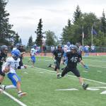 Mariners suffocate the Kodiak runner, led by Bernie Black on Saturday, Aug. 13, 2022, at Homer High School in Homer, Alaska. (Photo by Charlie Menke/ Homer News)