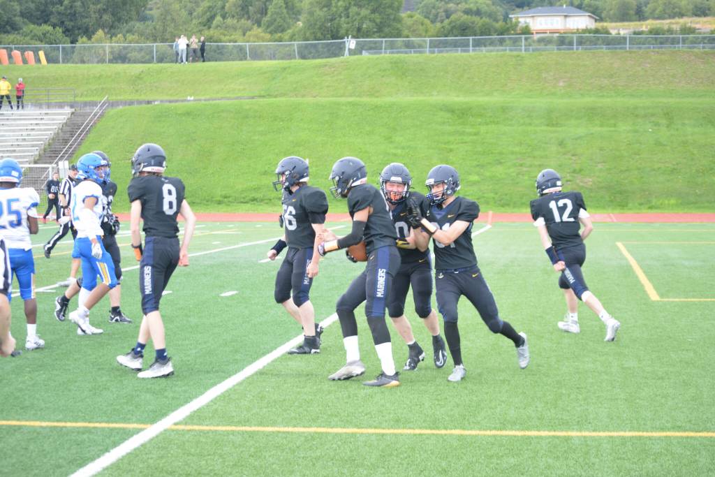 Mariners celebrate with scorer Morgen Techie on Saturday, Aug. 13, 2022, at Homer High School in Homer, Alaska. (Photo by Charlie Menke/ Homer News)