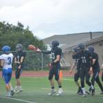 The Mariners celebrate after a crucial early score on Saturday, Aug. 13, 2022, at Homer High School in Homer, Alaska. (Photo by Charlie Menke/ Homer News)