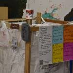 Signs and examples on the recycling super sack at the Cook Inletkeeper Community Action Studio show which plastics are desired as part of the project in Soldotna, Alaska, on Aug. 11, 2022. Plastics from types 1, 2, 4 and 5 can be deposited.(Jake Dye/Peninsula Clarion)