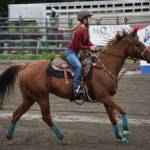 Evelyn Cooley competes in the barrel race at the Kenai Peninsula Fair on Aug. 12, 2022, in Ninilchik, Alaska. (Jake Dye/Peninsula Clarion)