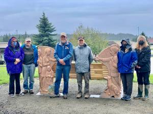 From left to right, Sara Murnane Berg, Ed Berg, Kim Zook, president of the Homer-Kachemak Bay Rotary Club, Bernie Griffard, past president, Linda Reinink-Smith, friend of Sara and Ed, Laura Kelley, treasurer, Homer-Kachemak Bay Rotary, pose for a photo on Tuesday, Aug. 9, after Zook presented the Bergs with a $2,000 check for the Loved & Lost Memorial Bench at the Homer Public Library in Homer, Alaska. (Photo provided)
