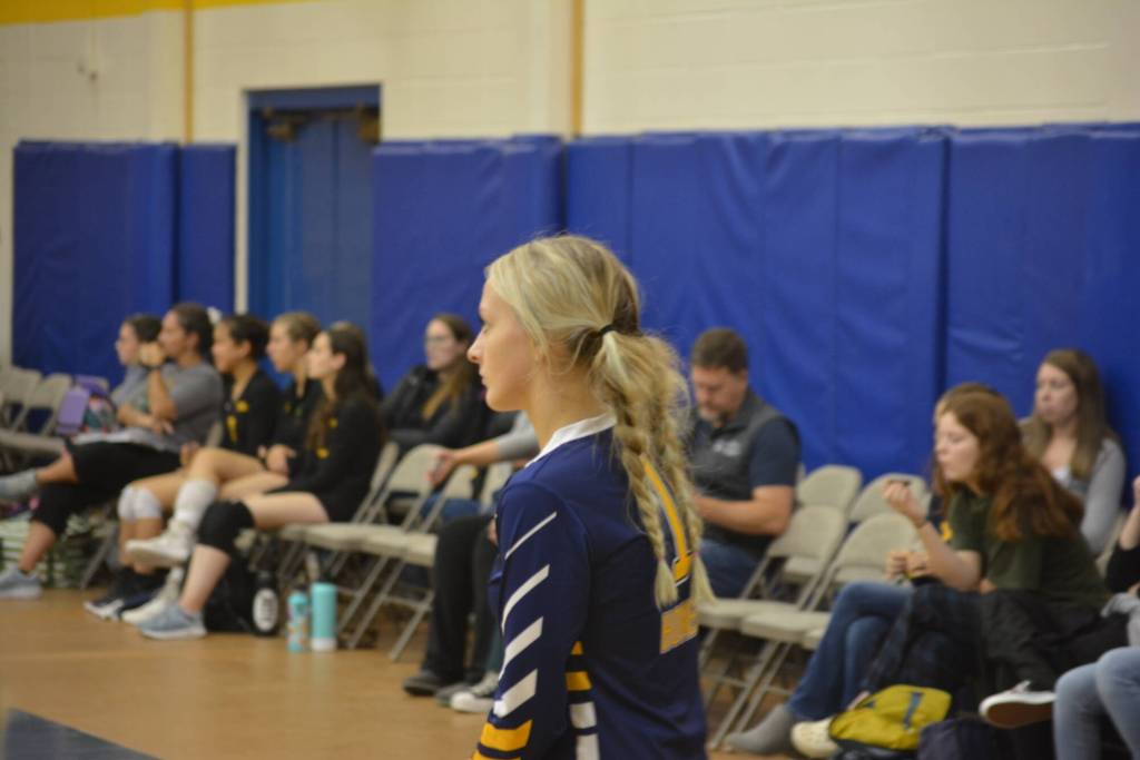 Isabel Dye readies herself to serve on Saturday, Aug. 20, 2022, at Homer High School in Homer, Alaska. (Photo by Charlie Menke/ Homer News)