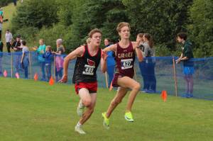 Kenai Central High Schools Gregory Fallon and Grace Christian Schools Robbie Annett run toward the finish line at the 2022 Ted McKenney XC Running Invitational at Skyview Middle School on Saturday, Aug. 20, 2022 in Soldotna, Alaska. (Ashlyn OHara/Peninsula Clarion)