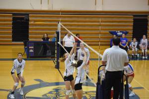 The Mariner front line attempts a block at Homer High School Alice Witte Gym on Wednesday, Aug. 24, 2022. (Photo by Charlie Menke/ Homer News)