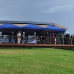 Visitors gather on the deck of Eva, the main house of the Storyknife Writers Retreat, on Monday, Aug. 29, 2022, for an open house. The six writers cabins are on either side of Eva. (Photo by Michael Armstrong/Homer News)