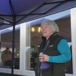 Storyknife Writers Retreat founder and writer Dana Stabenow speaks on the deck of Eva, the main cabin of the complex, at an open house on Monday, Aug. 29, 2022, at the retreat near Homer, Alaska. At left is Dave Girard, one of the carpenters who worked on the project and built the custom dining table for Eva, named after poet Eva Saulitis. (Photo by Michael Armstrong/Homer News)