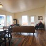 Homer Mayor Ken Castner relaxes in Eva, the main cabin of the Storyknife Writers Retreat, at an open house on Monday, Aug. 29, 2022, near Homer, Alaska. (Photo by Michael Armstrong/Homer News)