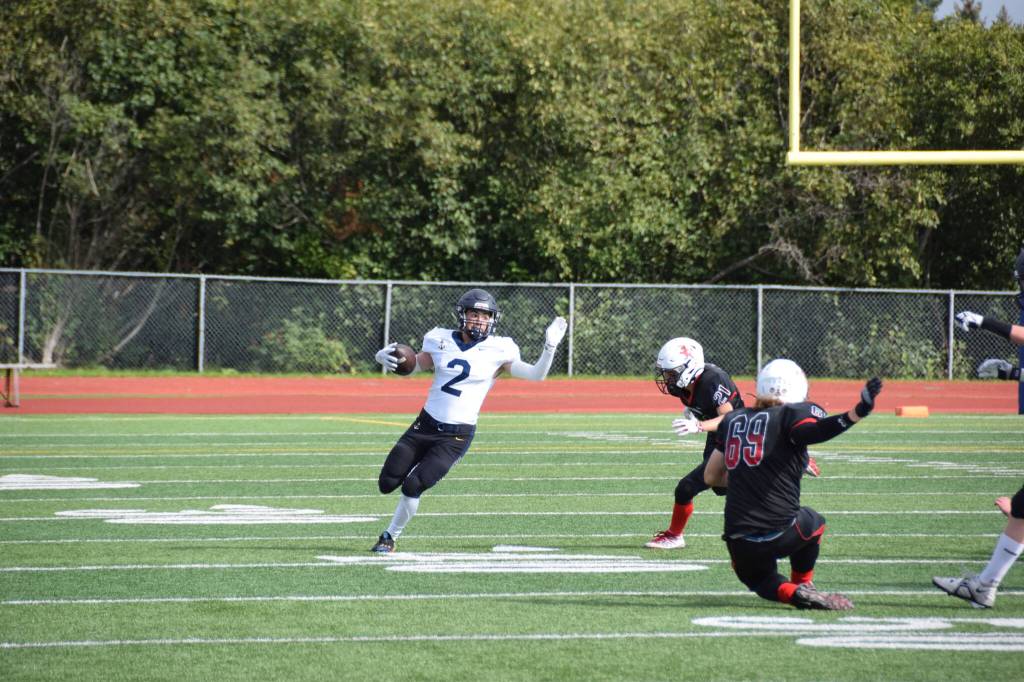 Junior Chris Martishev returning a punt on Saturday, Sep. 3, at the Homer High School Field in Homer, Alaska. (Photo by Charlie Menke/ Homer News)
