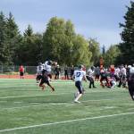 Martin catches the ball while being tackled on Saturday, Sep. 3, at the Homer High School Field in Homer, Alaska. (Photo by Charlie Menke/ Homer News)