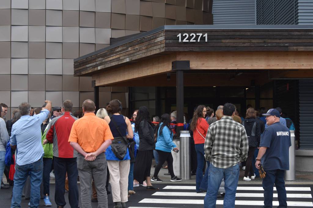 Members of the public and staff wait to enter the Kahtnuhtana Duhdeldiht Campus during an opening ceremony in Kenai, Alaska on Thursday, Sept. 1, 2022. (Jake Dye/Peninsula Clarion)