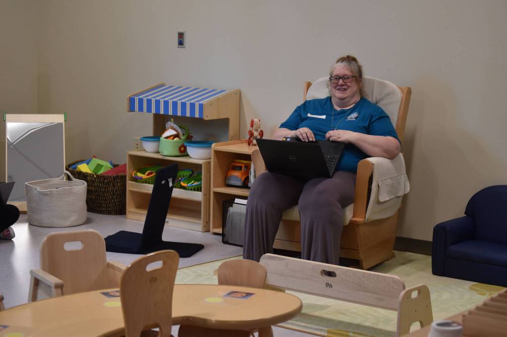 One of the educators for the toddler program at the Kahtnuhtana Duhdeldiht Campus prepares in a classroom on Thursday, Sept. 1, 2022, in Kenai, Alaska. (Jake Dye/Peninsula Clarion)