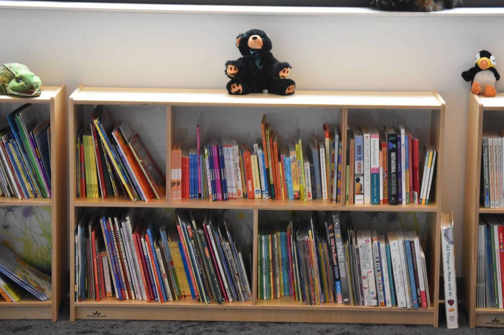 Books fill the shelves in the library at the Kahtnuhtana Duhdeldiht Campus in Kenai, Alaska, on Thursday, Sept. 1, 2022. (Jake Dye/Peninsula Clarion)
