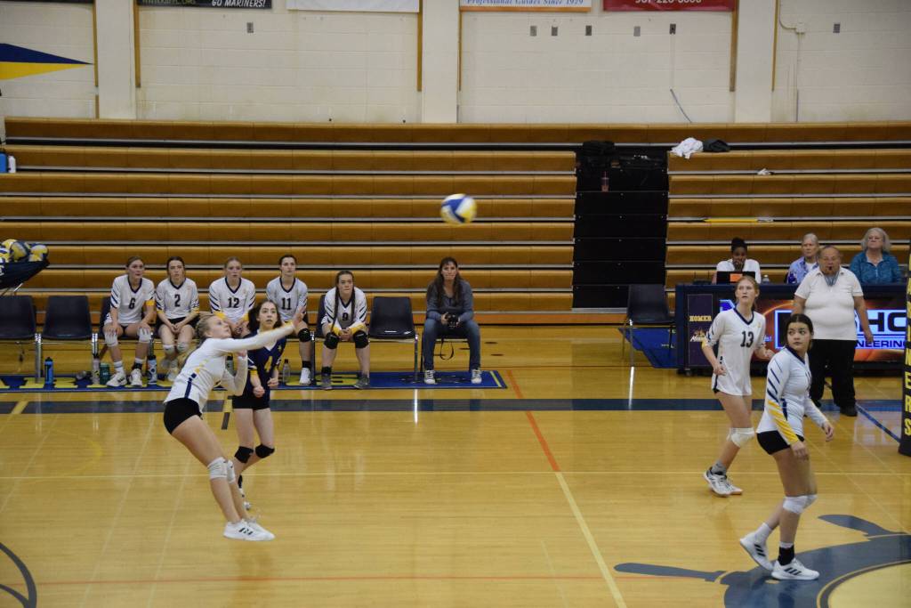 Senior Izzy Dye strikes on Saturday, Sept. 10, at Homer High School Gym. (Photo by Charlie Menke/ Homer News)