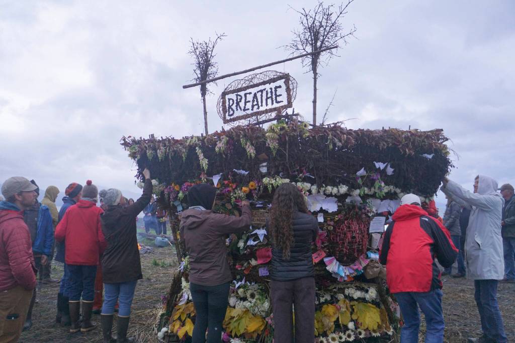 People interact with the 19th annual Burning Basket, Breathe, on Sunday, Sept. 11, 2022, at Mariner Park on the Homer Spit in Homer, Alaska. (Photo by Michael Armstrong/Homer News)