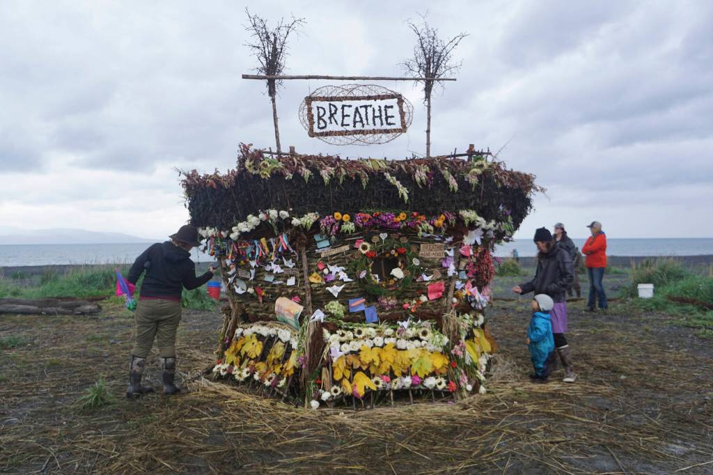 People interact with the 19th annual Burning Basket, Breathe, on Sunday, Sept. 11, 2022, at Mariner Park on the Homer Spit in Homer, Alaska. (Photo by Michael Armstrong/Homer News)
