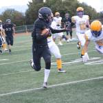 Mariner Morgan Techie slips by Barrow Whaler Jason Akpik on a successful run to score Homers first touchdown at homecoming on Friday, Sept. 16, 2022, in Homer, Alaska. (Photo by Michael Armstrong/Homer News)