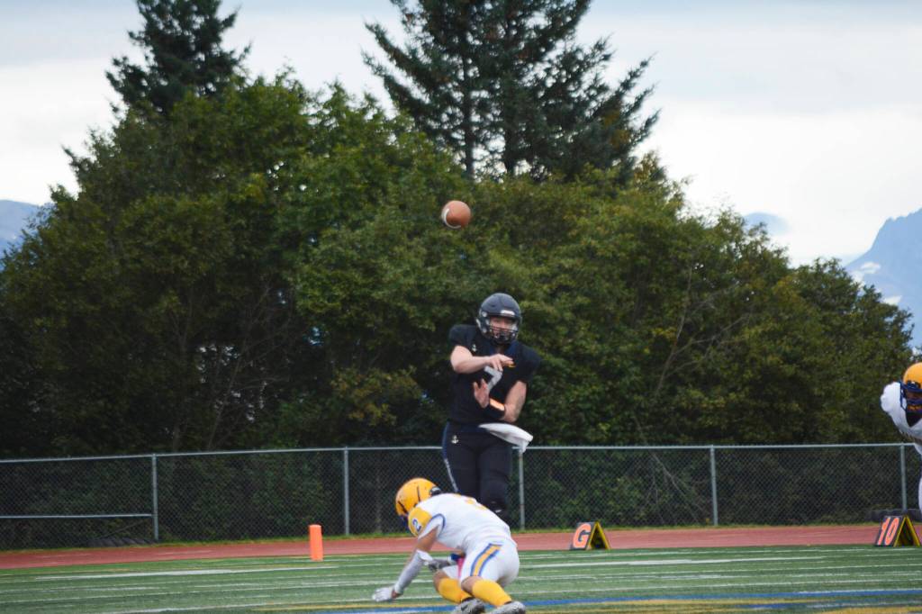 Mariner quarterback Carter Tennison drills the ball to Morgan Techie on a successful run by Techie to score Homers first touchdown at homecoming on Friday, Sept. 16, 2022, in Homer, Alaska. (Photo by Michael Armstrong/Homer News)