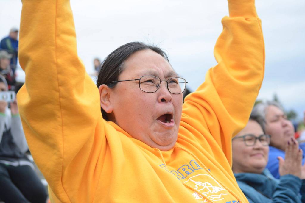 Stella Scott cheers as the Barrow Whalers of Utqiagvik make a touchdown on Friday, Sept. 16, 2022, at the Mariners vs. Whalers football game at Homer High School in Homer, Alaska. Scott lives in Homer, but her home town is Utqiagvik and she came to support the team with visiting residents from the farthest north Alaska city. (Photo by Michael Armstrong/Homer News)