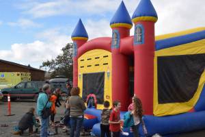 Kids bounce in an inflatable castle at the Kachemak City Park Grand Opening on Saturday, Sept. 17, 2022. (Photo by Charlie Menke / Homer News)