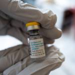 Registered pharmacist Sapana Patel holds a bottle of Monkeypox vaccine at a Pop-Up Monkeypox vaccination site on Wednesday, Aug. 3, 2022, in West Hollywood, Calif. (AP Photo/Richard Vogel, File)